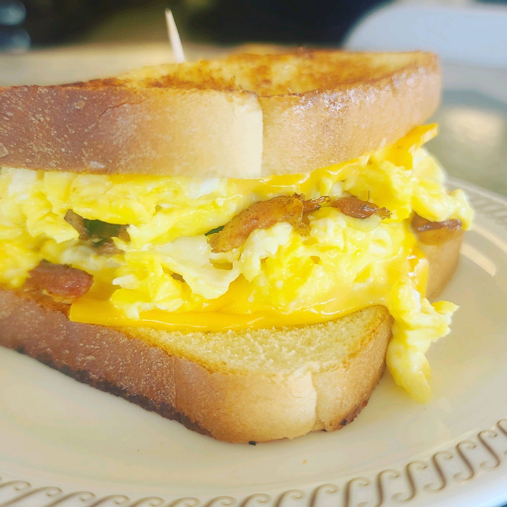 A 4 egg scramble with cheese sandwich with sugar bacon bites