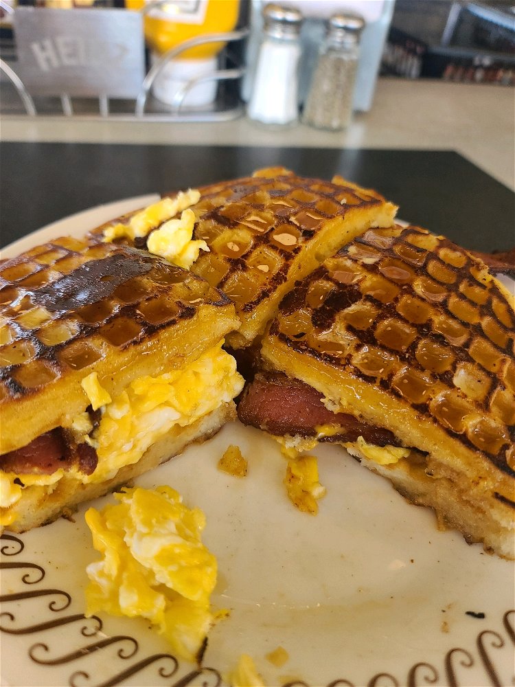 A bacon and egg cheese waffle sandwich