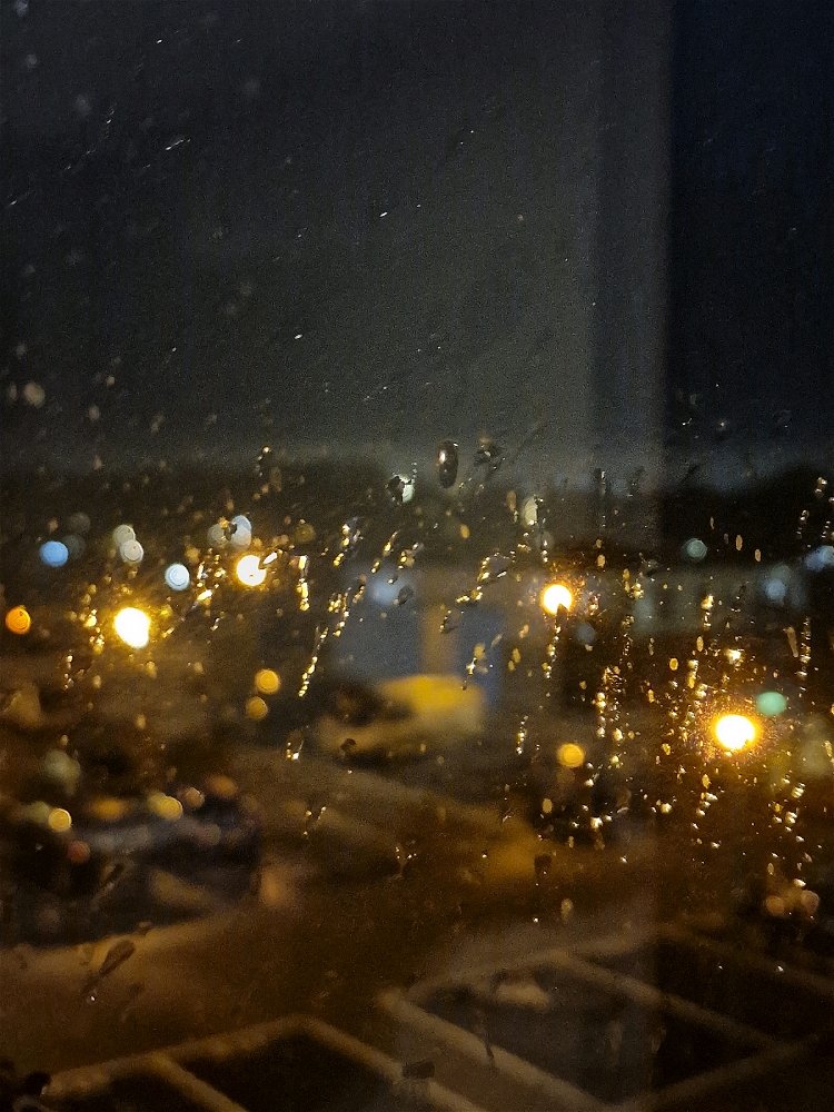 Rain drops on a window in the early morning.
