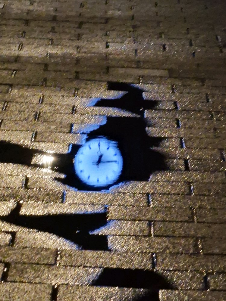 Clock reflection on a train station 
