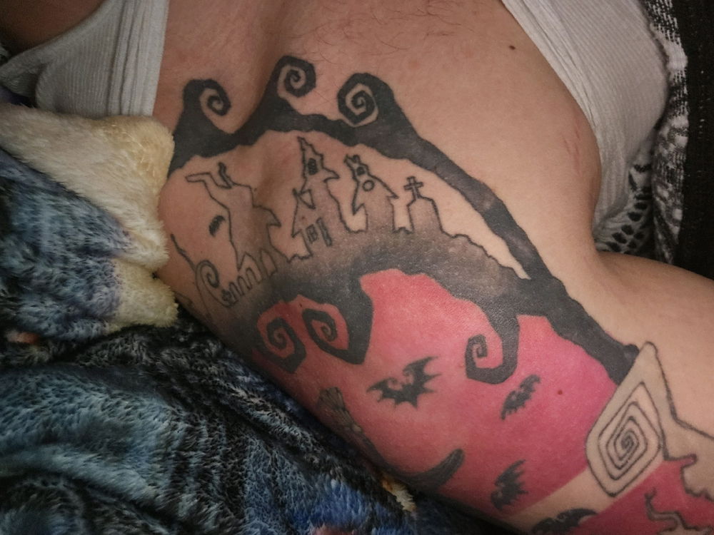I wanna get this colored in. But im so indecisive. Was thinking a dark purple or a snowy background, any ideas? (This is my shoulder collarbone are, its a nightmare before Christmas tattoo)