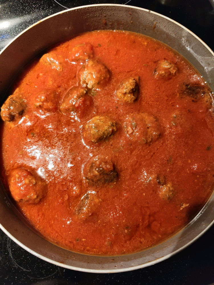 Uncooked sauce with fully cooked meatballs