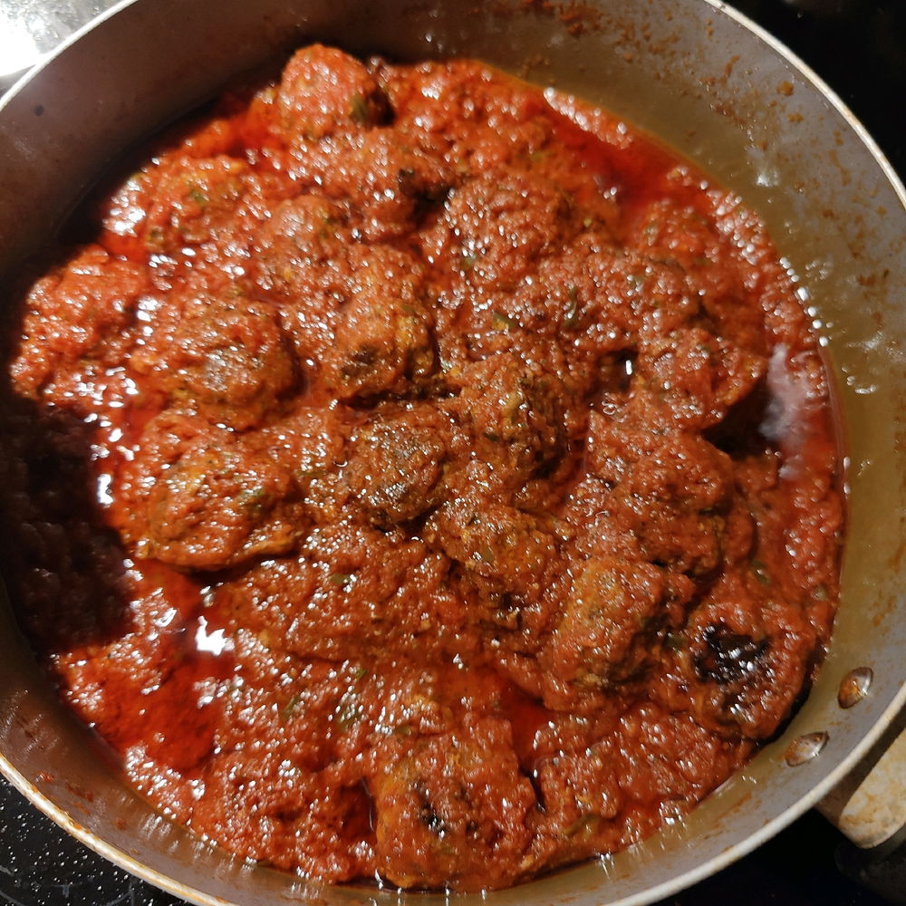 Cooked meat balls in a tomato and basil sauce