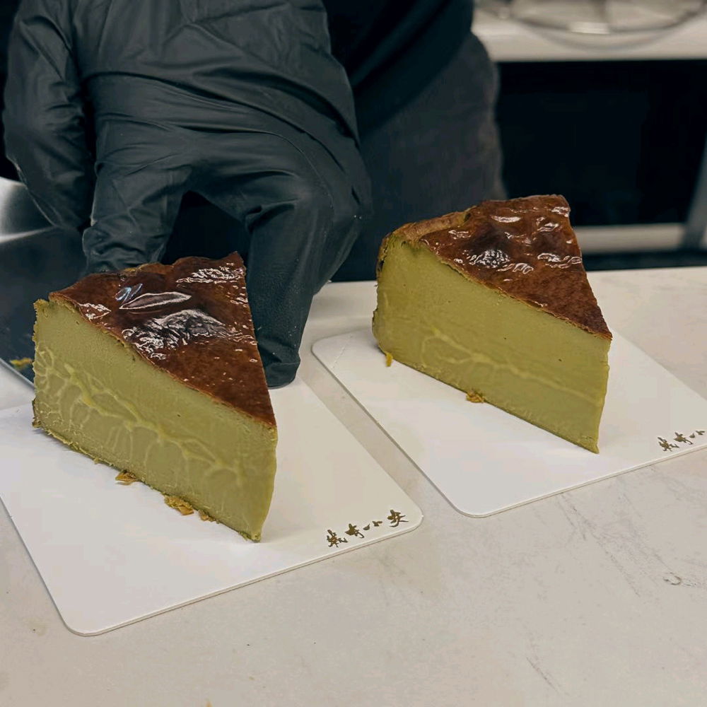 Iced latte with stewed white apricot jam and a pistachio Basque cheesecake.