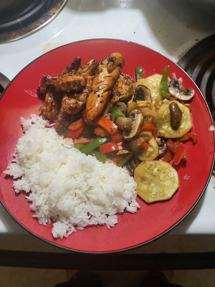 Pan fried chicken, stir fried vegetables, and rice