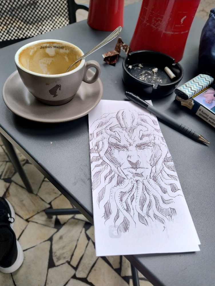 Capuccino, cigarettes, paper, pen